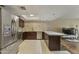 Open kitchen features stainless steel appliances, granite counters, and an adjacent dining area at 7840 E Camelback Rd # 110, Scottsdale, AZ 85251