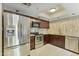 Kitchen featuring stainless steel appliances, granite counters, and dark wood cabinetry at 7840 E Camelback Rd # 110, Scottsdale, AZ 85251