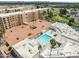 Aerial view shows a large community pool and surrounding residential buildings at 7840 E Camelback Rd # 110, Scottsdale, AZ 85251