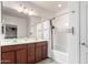 Bright bathroom featuring a double sink vanity with warm wood cabinetry and a shower-tub combo at 903 E Jacob St, Chandler, AZ 85225