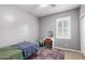Well-lit bedroom with a bed, a desk and chair, a colorful rug, and natural light from a window at 903 E Jacob St, Chandler, AZ 85225