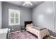 Comfortable bedroom featuring a single bed, colorful rug, ceiling fan and a window at 903 E Jacob St, Chandler, AZ 85225