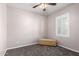 Cozy bedroom with neutral walls, plush carpeting, ceiling fan and natural light from the window at 903 E Jacob St, Chandler, AZ 85225