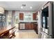 Bright kitchen area with stainless steel appliances, dark wood cabinets, and a view to outdoor pool area at 903 E Jacob St, Chandler, AZ 85225