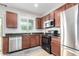 Bright kitchen area with stainless steel appliances and dark wood cabinets, with granite countertops at 903 E Jacob St, Chandler, AZ 85225