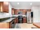 Bright kitchen area with stainless steel appliances and dark wood cabinets, with granite countertops at 903 E Jacob St, Chandler, AZ 85225
