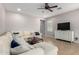 Inviting living room with neutral walls, tile flooring, a ceiling fan, and comfortable, oversized sectional at 903 E Jacob St, Chandler, AZ 85225