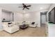 Inviting living room with neutral walls, tile flooring, a ceiling fan, and comfortable, oversized sectional at 903 E Jacob St, Chandler, AZ 85225