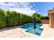 Inviting pool area with a waterfall feature, lush greenery, blue skies, and space for outdoor seating at 903 E Jacob St, Chandler, AZ 85225