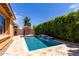 Sparkling pool with tile accents and lush landscaping provides a serene backyard retreat at 903 E Jacob St, Chandler, AZ 85225