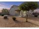 Well maintained backyard with desert landscaping featuring a covered patio and stucco wall at 9303 W Oregon Ave, Glendale, AZ 85305