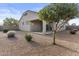 Expansive backyard featuring a covered patio and well-maintained desert landscaping at 9303 W Oregon Ave, Glendale, AZ 85305