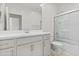 Bright bathroom features a white vanity with double sinks, a framed mirror, and a glass-enclosed shower at 9303 W Oregon Ave, Glendale, AZ 85305