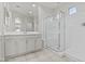 Elegant bathroom featuring a vanity with double sinks and a framed shower, offering a luxurious experience at 9303 W Oregon Ave, Glendale, AZ 85305