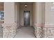 Welcoming front entry with a modern door, decorative stone accents, and a covered porch at 9303 W Oregon Ave, Glendale, AZ 85305
