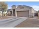 Stylish single-Gathering home highlighting a two car garage, neutral landscaping, and a covered porch at 9303 W Oregon Ave, Glendale, AZ 85305