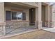 Inviting front porch with decorative stone accents, a covered entryway, and desert landscaping at 9303 W Oregon Ave, Glendale, AZ 85305