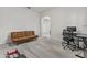 Versatile home office with a futon couch, desk, and view into the hallway through an arched doorway at 9303 W Oregon Ave, Glendale, AZ 85305