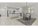 Contemporary kitchen featuring stainless steel appliances, granite countertops, and a dining table at 9303 W Oregon Ave, Glendale, AZ 85305