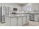 Modern kitchen with white cabinets, granite countertops, stainless steel appliances, and a center island at 9303 W Oregon Ave, Glendale, AZ 85305