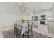 Bright, open-concept kitchen featuring modern lighting, stainless appliances, and a center island at 9303 W Oregon Ave, Glendale, AZ 85305
