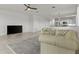 Open concept living room flowing into the kitchen, featuring tile flooring, neutral walls, and comfortable seating at 9303 W Oregon Ave, Glendale, AZ 85305