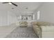 Open living space leading to a bright kitchen with modern furnishings, including a sofa and chair at 9303 W Oregon Ave, Glendale, AZ 85305