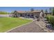 Spacious backyard featuring a large lawn, patio with dining set, and well-maintained landscaping at 9466 E Laurel Ln, Scottsdale, AZ 85260