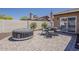 Well-designed patio with a dining set, hot tub, and sleek pavers for outdoor entertainment at 9466 E Laurel Ln, Scottsdale, AZ 85260