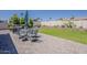 Outdoor dining set with a built-in grill, lush lawn, and privacy wall create an ideal backyard patio at 9466 E Laurel Ln, Scottsdale, AZ 85260
