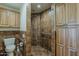 Bathroom with tiled shower, toilet, and wood cabinets, plus accessibility features at 9466 E Laurel Ln, Scottsdale, AZ 85260