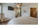 This bedroom features dark wood floors, ceiling fan, and view into the living area at 9466 E Laurel Ln, Scottsdale, AZ 85260