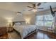 Bedroom with hardwood floors, ceiling fan, mini-split air conditioning, and sunny window at 9466 E Laurel Ln, Scottsdale, AZ 85260