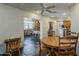 Charming dining area open to kitchen, with wood table, chairs and ceiling fan at 9466 E Laurel Ln, Scottsdale, AZ 85260