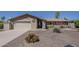 Charming single-story home showcasing attractive landscaping and a convenient two-car garage at 9466 E Laurel Ln, Scottsdale, AZ 85260
