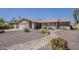 Charming single-story home featuring a well-kept desert landscape and a two-car garage at 9466 E Laurel Ln, Scottsdale, AZ 85260