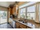Kitchen with stainless steel appliances, granite counters, and view to the backyard patio at 9466 E Laurel Ln, Scottsdale, AZ 85260