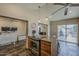 Kitchen island with range, granite countertop, and backyard patio access at 9466 E Laurel Ln, Scottsdale, AZ 85260