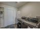 Laundry room with modern washer and dryer set, plus shelving and exterior access at 9466 E Laurel Ln, Scottsdale, AZ 85260