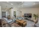 Bright living room featuring tile floors, fan and comfortable seating arrangements at 9466 E Laurel Ln, Scottsdale, AZ 85260