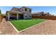 Expansive backyard with lush artificial turf and a covered patio, perfect for outdoor entertaining at 9548 E Rainbow Ave, Mesa, AZ 85212