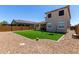 Lush backyard with artificial turf and low-maintenance desert landscaping, providing a serene outdoor space at 9548 E Rainbow Ave, Mesa, AZ 85212