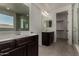 This bathroom features double sinks with dark cabinetry, a glass-enclosed shower, and a luxurious soaking tub at 9548 E Rainbow Ave, Mesa, AZ 85212