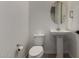 This bathroom boasts a pedestal sink, modern fixtures, and an oval mirror that enhances the space's aesthetic at 9548 E Rainbow Ave, Mesa, AZ 85212