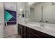 Bathroom featuring double sinks, large mirror, and neutral color palette at 9548 E Rainbow Ave, Mesa, AZ 85212