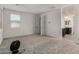 Bright bedroom featuring neutral carpet, a window for natural light, and access to an adjacent bathroom at 9548 E Rainbow Ave, Mesa, AZ 85212