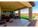 Inviting covered patio area with comfortable seating and access to a well-maintained backyard at 9548 E Rainbow Ave, Mesa, AZ 85212