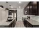 Modern kitchen features dark cabinets, stainless steel appliances, granite countertops, and subway tile backsplash at 9548 E Rainbow Ave, Mesa, AZ 85212