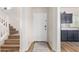 Bright entryway features a staircase and a glimpse into the modern kitchen at 10239 W Via Del Sol -- # 400, Peoria, AZ 85383