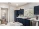 A kitchen featuring sleek, navy cabinets, stainless steel appliances, and crisp white countertops at 10239 W Via Del Sol -- # 400, Peoria, AZ 85383